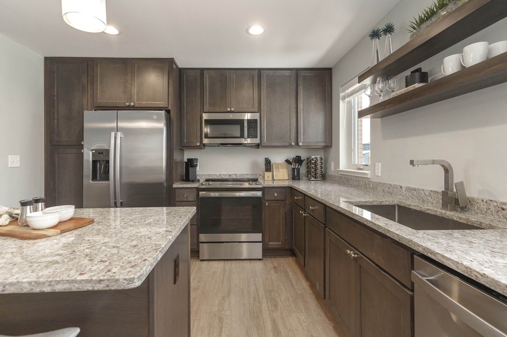 a kitchen with stainless steel appliances and granite counter tops